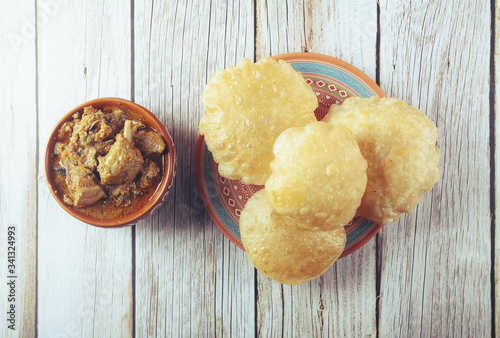 South Indian traditional food Poori or puri with country chicken curry photo