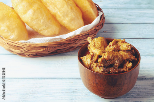 South Indian traditional food Poori or puri with country chicken curry 