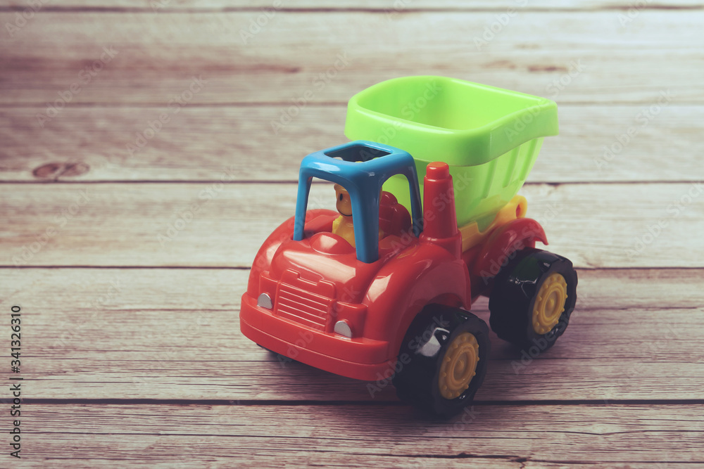 Fototapeta premium Kid's toy dump truck isolated on white 