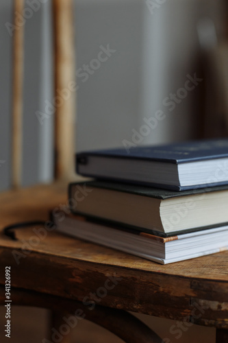 three books lie on a wooden.