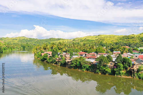Tropical landscape in sunny weather. Village by the river. The nature of the Philippines, Samar