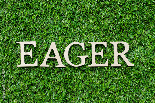 Wood alphabet letter in word eager on green grass background