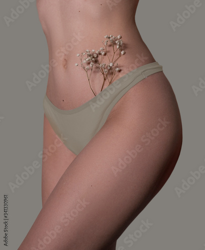 Beautiful photo of a bikini area. Flowers in underpants.
Moles on a half-naked body. Flowers in the bikini zone. 
