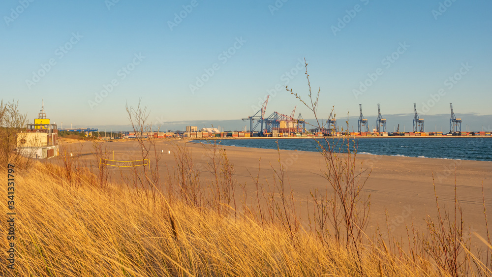 Stogi beach with dunes and deep water terminal (DCT Gdansk, Poland. Container facility).