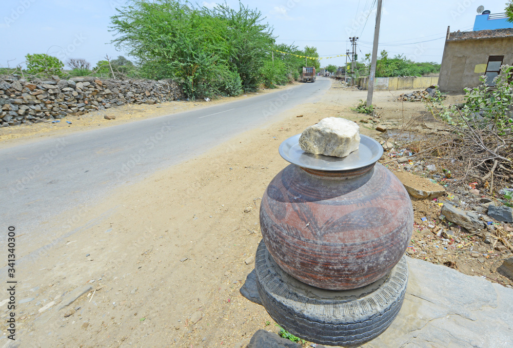 Obraz premium Clay pot with drinking water on roadside at a village during summer hot day in Beawar, Rajasthan, India.