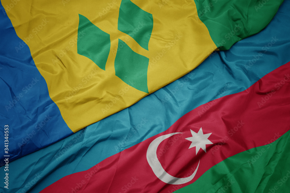 waving colorful flag of azerbaijan and national flag of saint vincent and the grenadines. waving colorful flag of azerbaijan and national flag of saint vincent and the grenadines.