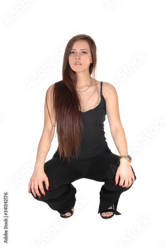 Lovely young woman crouching on the floor