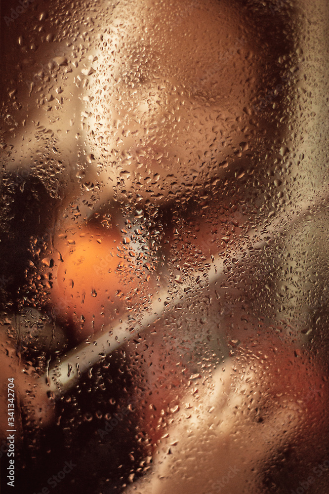Girl with a violin behind a glass window with drops of water, low key. Music concept Girl with a violin behind a glass window with drops of water, low key. Music concept