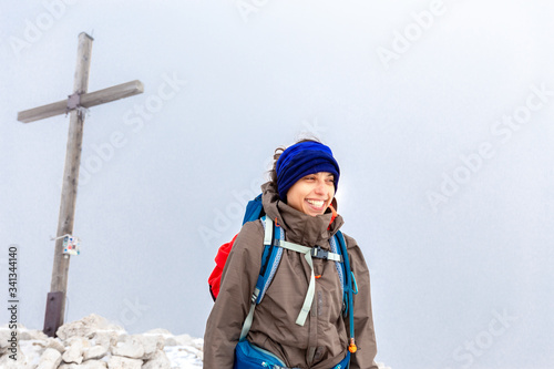 Backpacker woman tourist standing Peitlerkofel mountain summit Italy photo