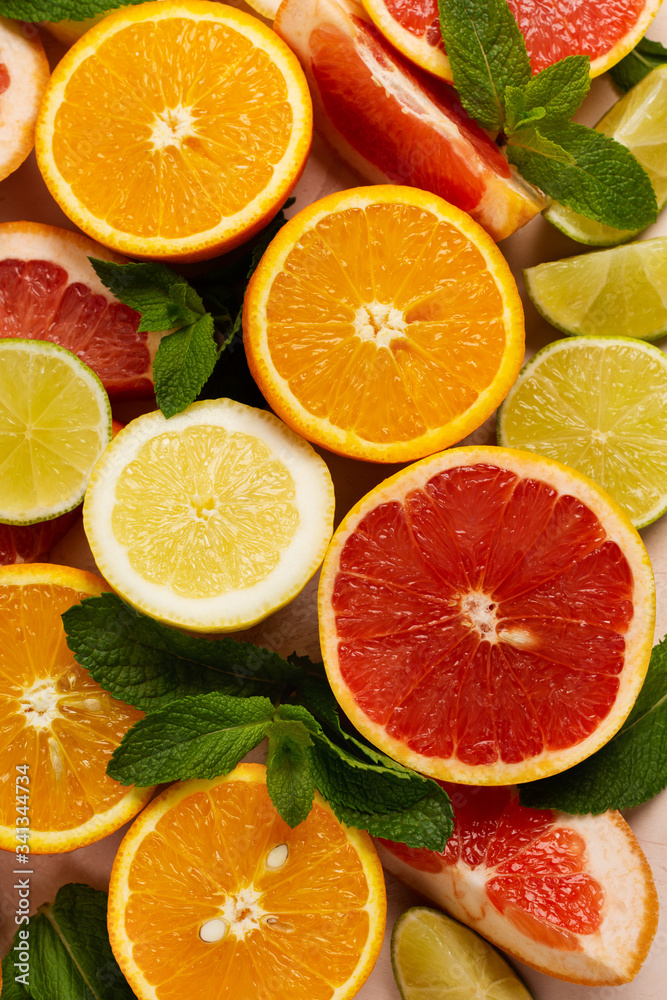 Fototapeta premium Orange, lemon, grapefruit, mandarin and lime on trendy pink stone or concrete table background. Citrus fruits. Top view, flat lay