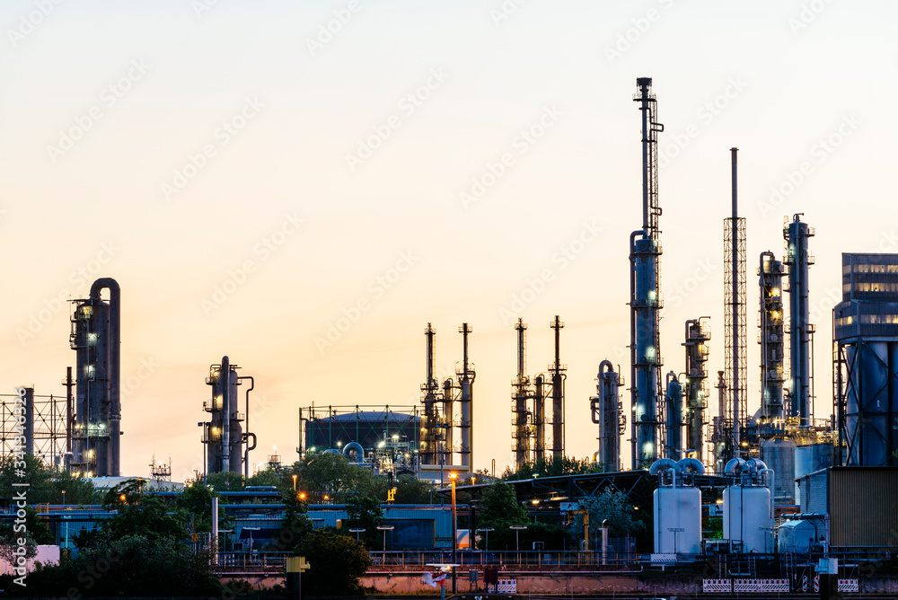 Exhaust systems of the chemical industry against the evening sky Exhaust systems of the chemical industry against the evening sky