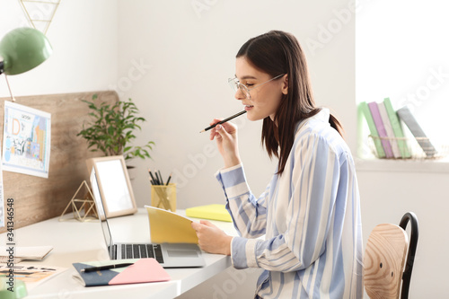 Young female designer worki...