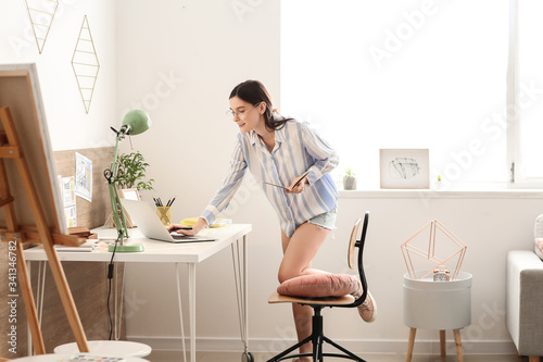 Young female designer worki...