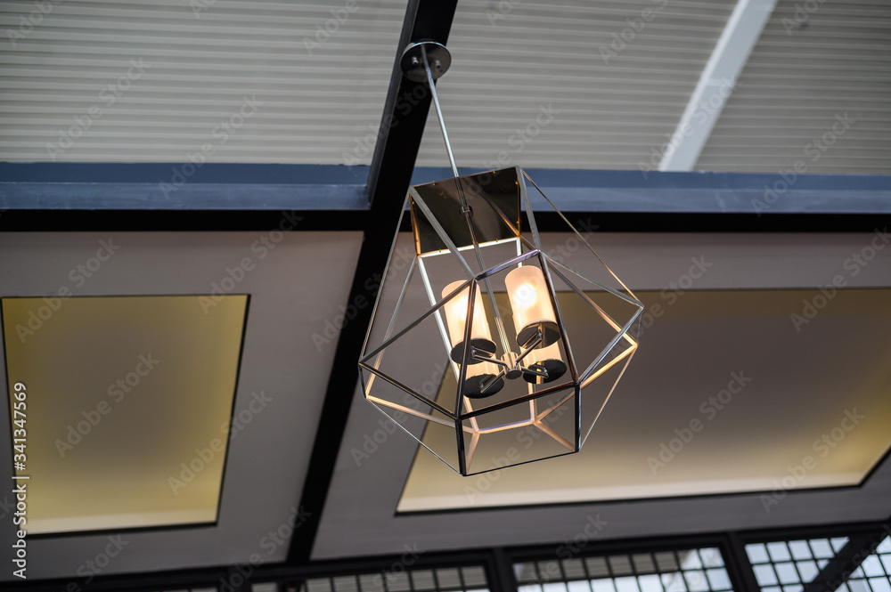 Metal hanging lamp in modern interior.