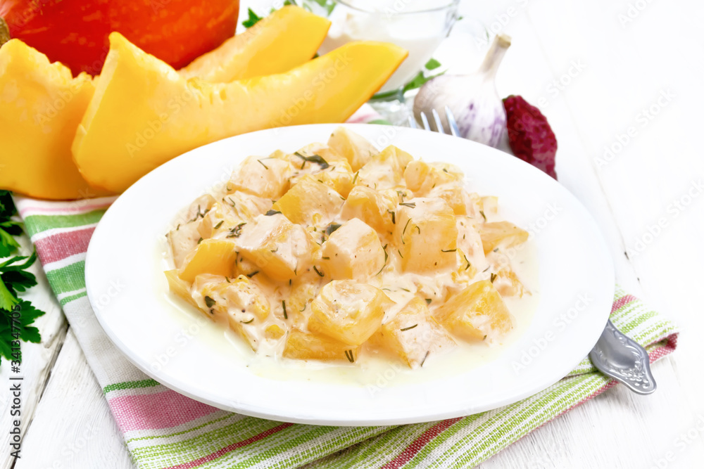 Pumpkin with sour cream sauce in plate on board Pumpkin with sour cream sauce in plate on board