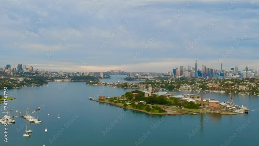 Panoramic drone aerial view over Sydney harbour on a cloudy sunset showing the nice colours of the harbour foreshore Panoramic drone aerial view over Sydney harbour on a cloudy sunset showing the nice colours of the harbour foreshore