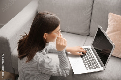 Young woman with laptop wor...