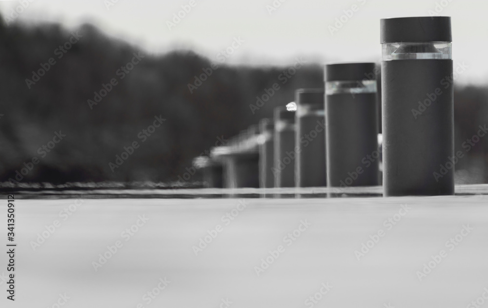 
Small lampposts by the sea, monochrome