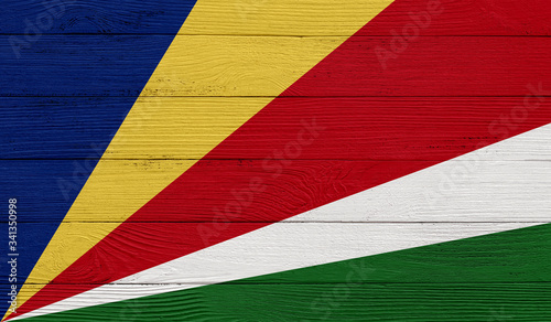 Seychelles flag on a wooden texture. Wood texture, planks Wooden texture background flag. Flag painted with paints on wood