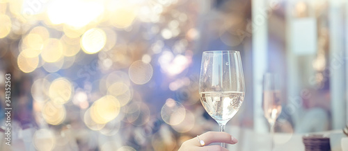 white wine glass in an outdoor cafe, spring view in a restaurant