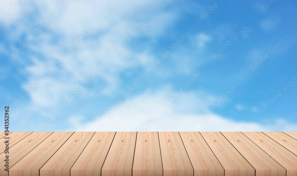 wooden table with blurred of blue sky with clouds on background - For product display. Wood table and tropical landscape in the background.. Spring or summer abstract nature background.