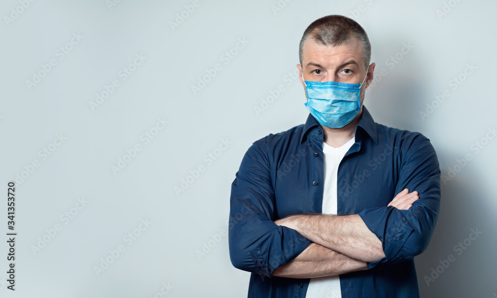 Man Wearing Protective Medical Mask Standing Over Gray Studio Background