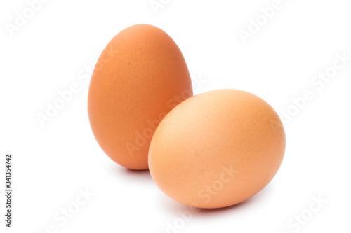 Two fresh brown chicken eggs on a white background
