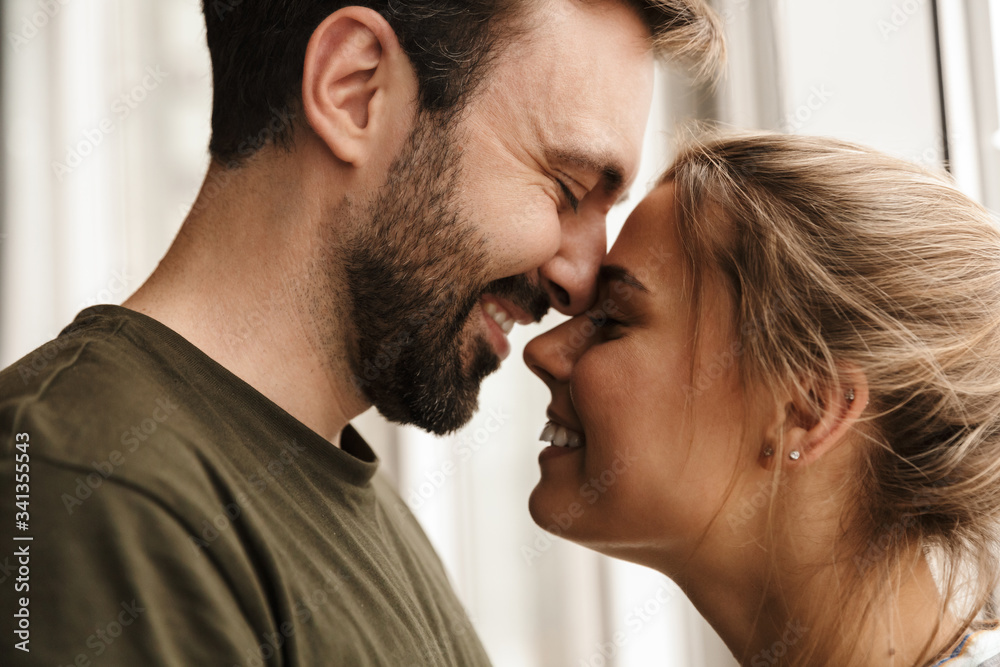 Photo of romantic cute couple smiling and hugging while standing Photo of romantic cute couple smiling and hugging while standing