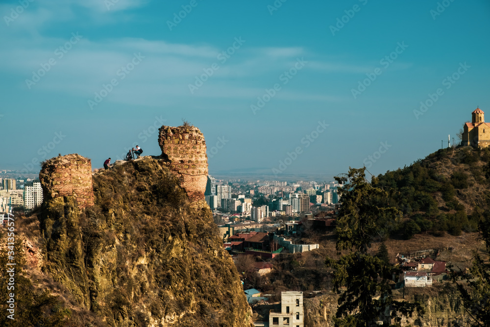 Naklejka premium Panorama of the city of Tbilisi from a high point. Tiled roofs of old houses. View of the old city.