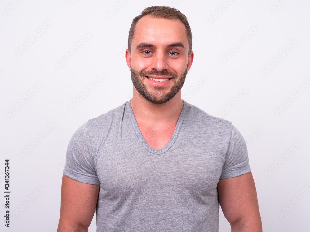 Portrait of happy muscular bearded man smiling Portrait of happy muscular bearded man smiling