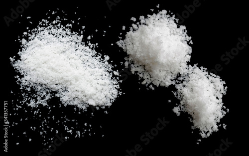  salt on a black background salt on wooden spoon isolated on white background A pile of coarse salt on a black background
