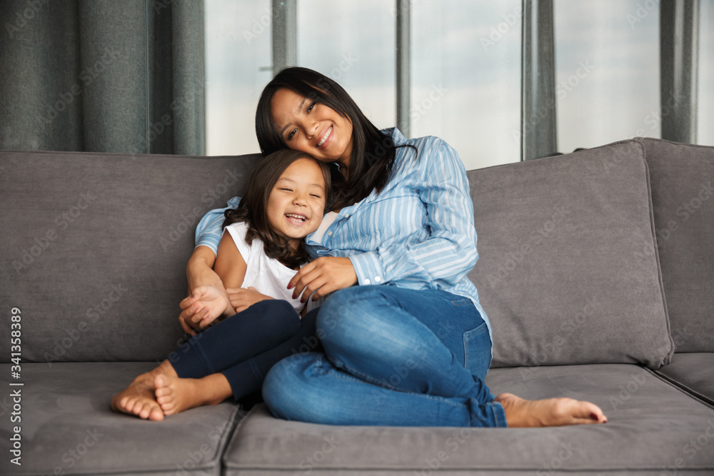 Photo of pregnant woman with her little daughter hugging and smiling Photo of pregnant woman with her little daughter hugging and smiling