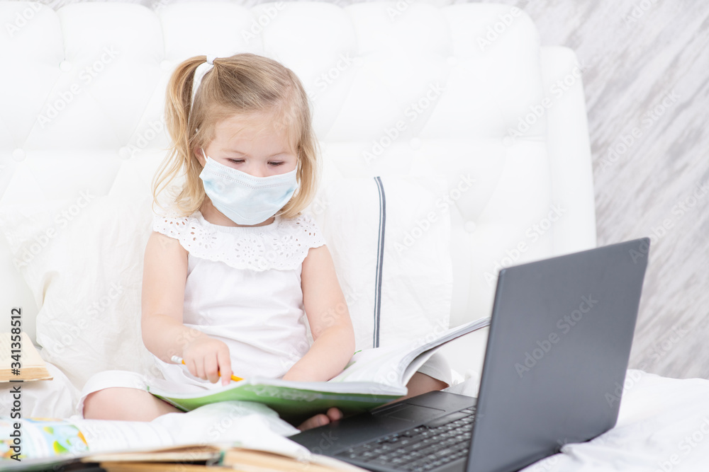Child girl student in medical face mask homework online lesson at home, epidemic Coronavirus, MERS-CoV, 2019-nCoV, quarantine, Covid-19 self-isolation, online education, home schooling Child girl student in medical face mask homework online lesson at home, epidemic Coronavirus, MERS-CoV, 2019-nCoV, quarantine, Covid-19 self-isolation, online education, home schooling