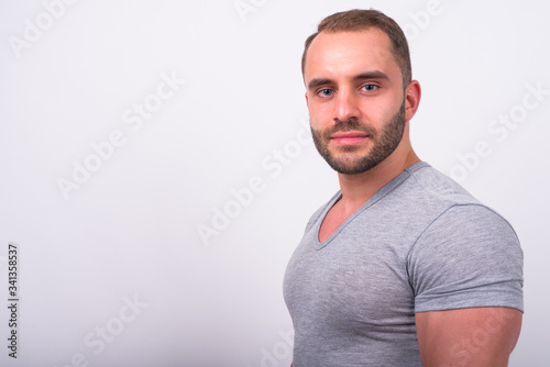 Profile view of muscular bearded man looking at camera