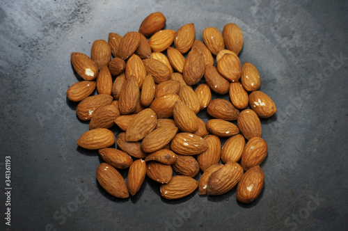 Roast almond peanut on a black skillet. 