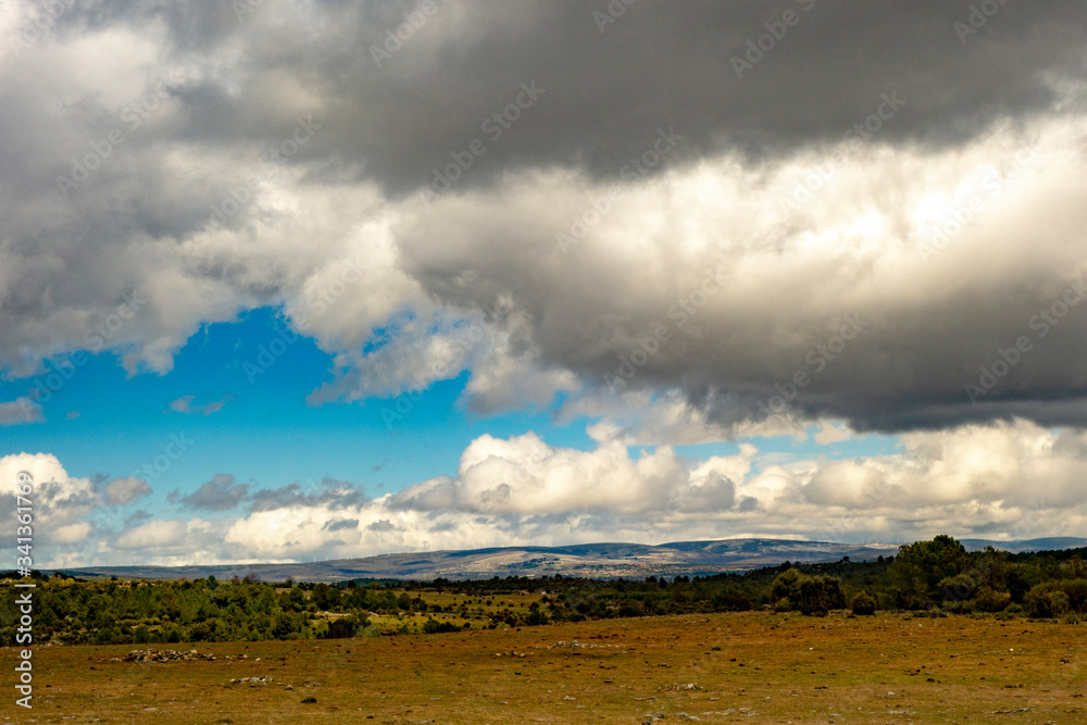 Landscape with far view of mountains near San Bartolome de Pinares on Saint James way, Camino de Levante from Toledo to Avila in Spain Landscape with far view of mountains near San Bartolome de Pinares on Saint James way, Camino de Levante from Toledo to Avila in Spain