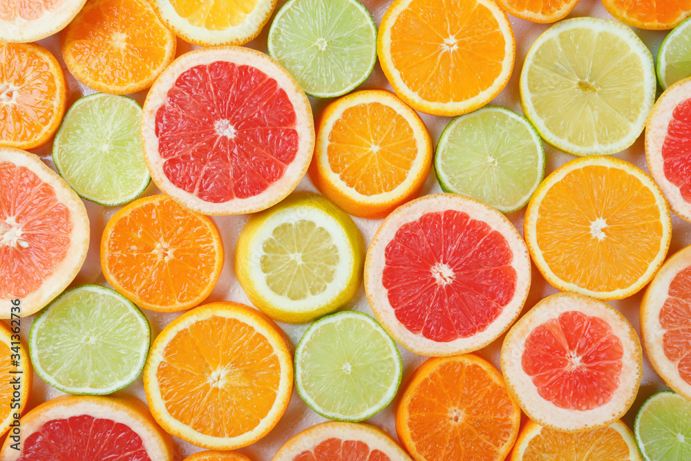 Flat lay of citrus fruits like lime, lemon, orange and tangerine Flat lay of citrus fruits like lime, lemon, orange and tangerine