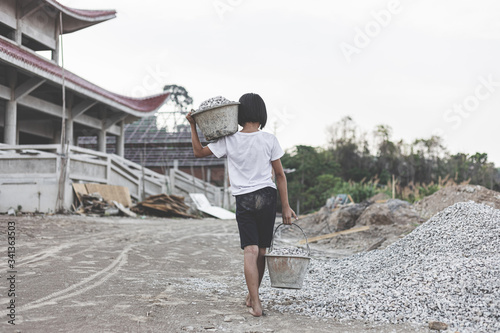 poor little girl working at construction site for world day against child labor concept: