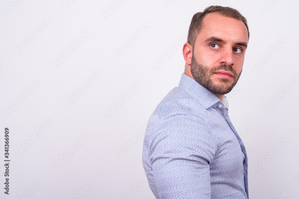 Profile view of bearded businessman looking back Profile view of bearded businessman looking back