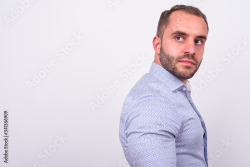 Profile view of bearded businessman looking back