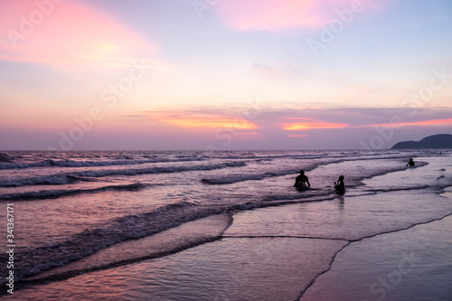 memories of summer, pink sunset light on the beach, family people on the beach