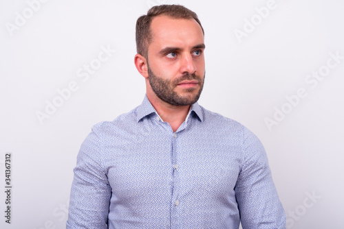 Portrait of bearded businessman thinking and looking up