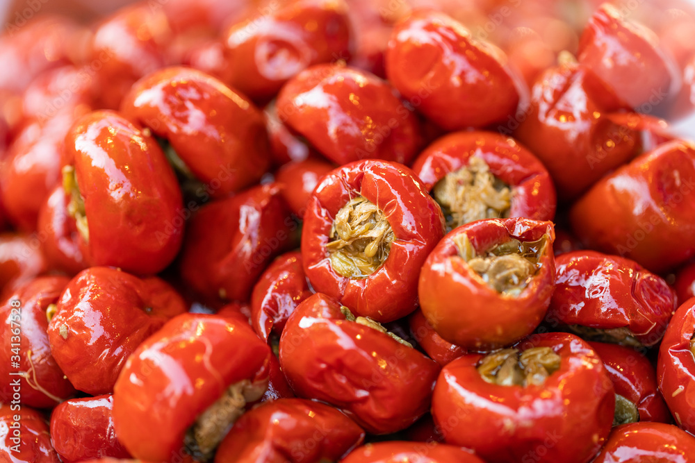 Pickled cherry, Hot cherry peppers stuffed with anchovies and capers, closeup, Italian traditional dish, peppers background, street food market Pickled cherry, Hot cherry peppers stuffed with anchovies and capers, closeup, Italian traditional dish, peppers background, street food market