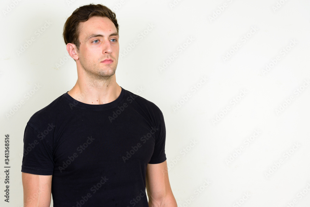 Portrait of young handsome man thinking and looking up Portrait of young handsome man thinking and looking up