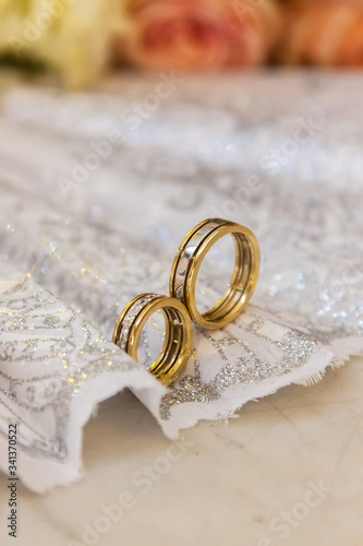 wedding rings on a wedding dress, a composition of rings with precious stones