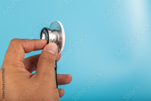 Man hand with Stethoscope isolated on blue background