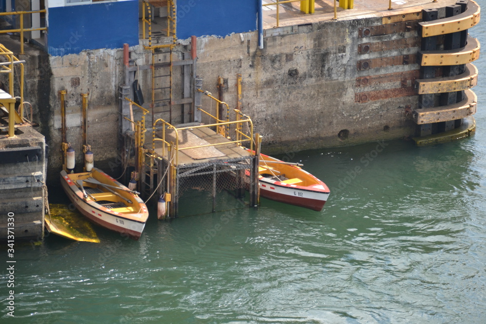 Panama Canal Rowboats where men in rowboats go to the ship to toss the lines that will connect the ship to the 