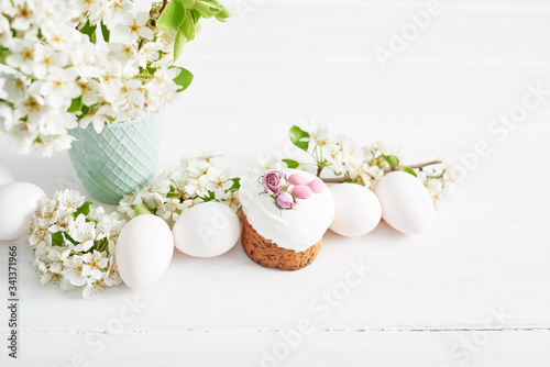 Easter sweet bread, Easter cake with flowers and gingerbread. Holidays breakfast concept with copy space. Easter greeting card template. Homemade pasques.Easter sweets on white background.