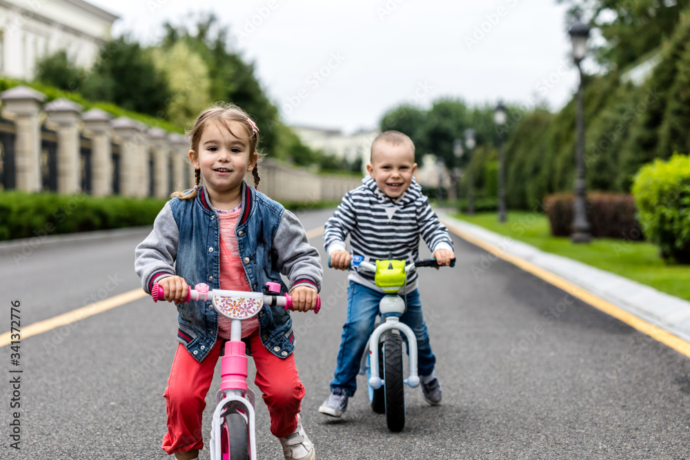 Happy kids with bikes having fun on the road at the day time. Happy kids with bikes having fun on the road at the day time.