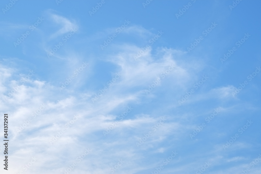 Group of white fluffy clouds and blue sky.